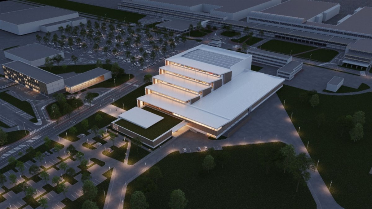 Nočna zračna vizualizacija modernega kompleksa z osvetljenimi terasami in parkirišči.