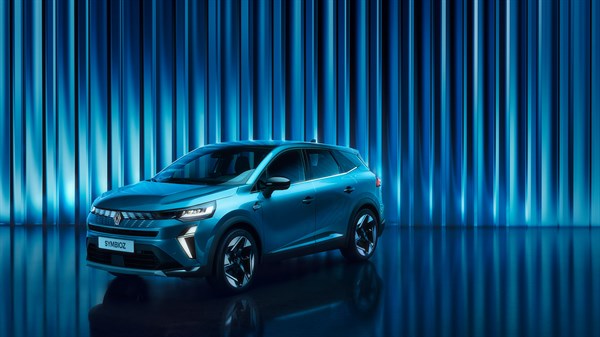 Modri Renault Symbioz parkiran ob modri svetlobni zavesi.