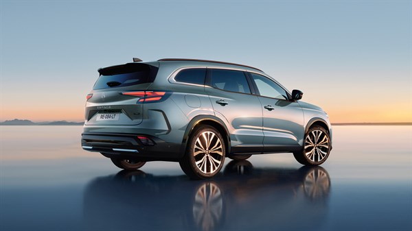 Renault Espace, pogled od zadaj pod kotom, parkiran na zrcalni površini ob sončnem zahodu.