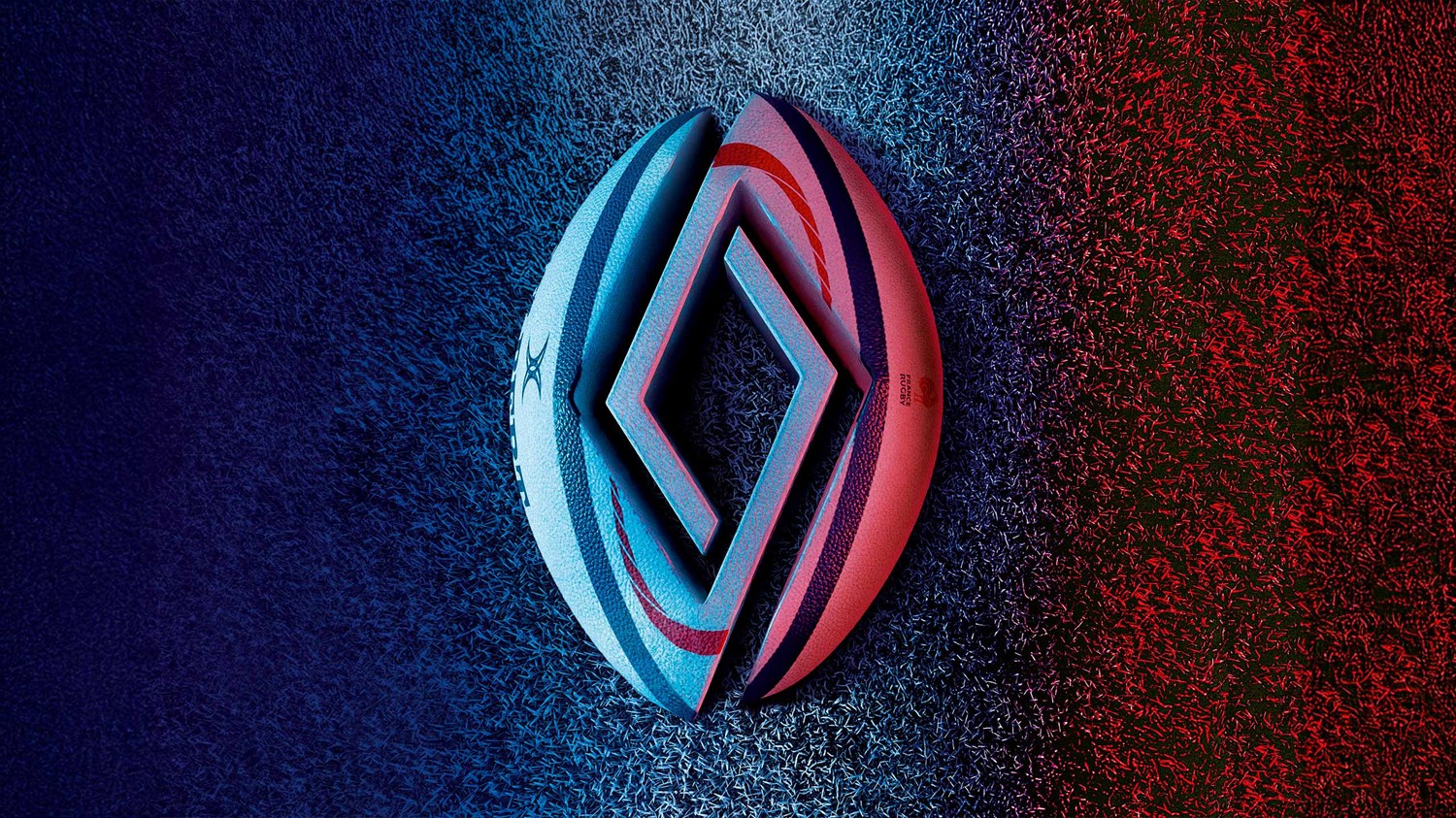 Logotip Renault znotraj žoge, ma travnati podlagi, v modro-rdeči osvetlitvi.