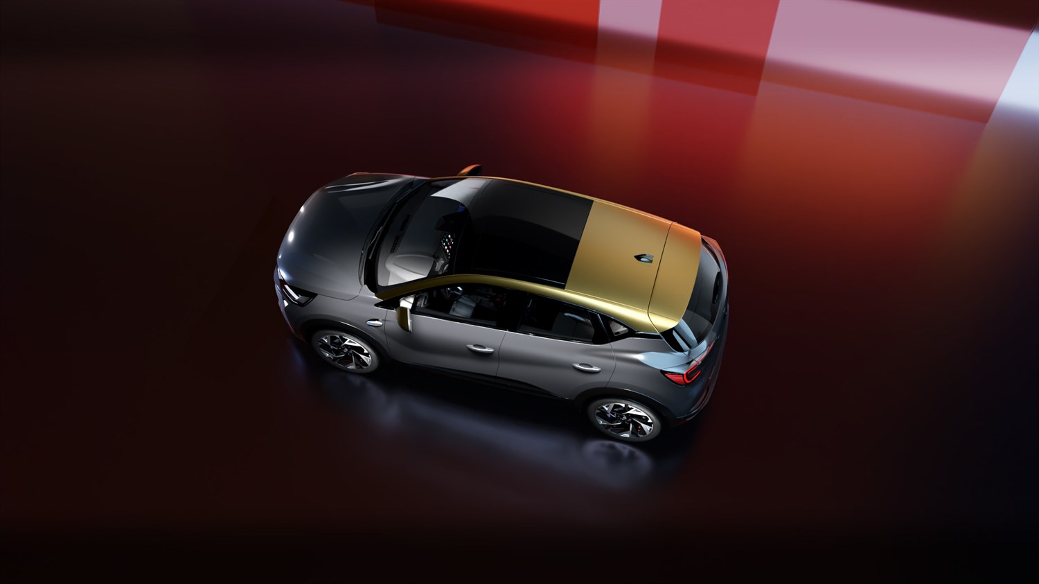 Renault Captur od zgoraj, z dvobarvno karoserijo – temno siva spodaj in zlato-rumena streha.