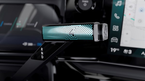 Tipka menjalnika Renault 4 E-Tech Electric z osvetljenim zeleno-belim vzorcem in označbami R, N, D ob strani.