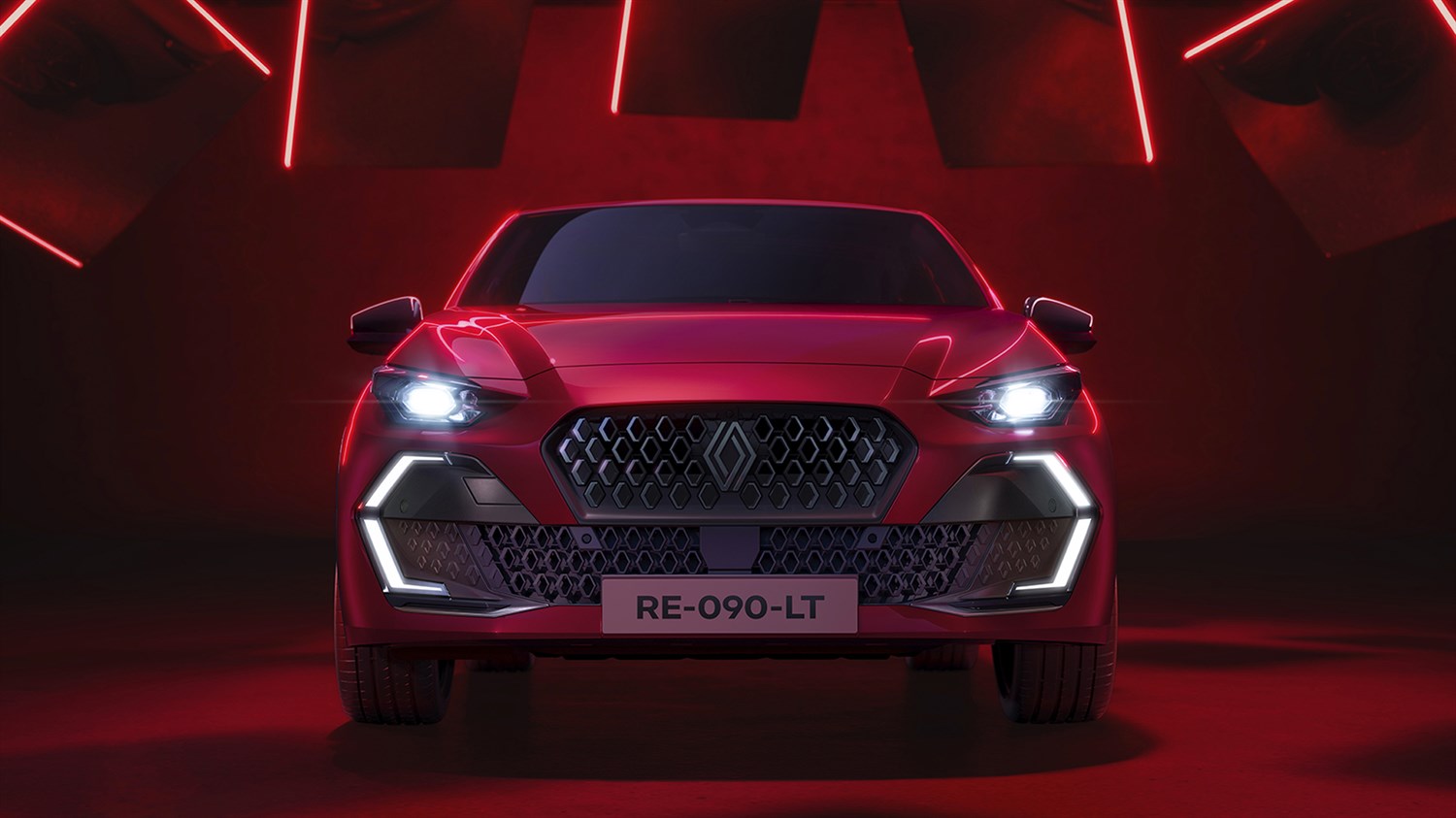 Sprednji pogled na novi Renault Clio v rdečem studiu razkriva izrazito masko in značilne LED-luči.