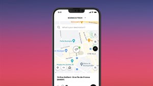 Pametni telefon z aplikacijo My Renault na zaslonu, ki prikazuje zemljevid z iskanjem polnilnih postaj za Renault Scenic E-Tech electric.