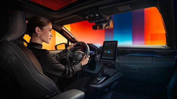 Voznica, ki uporablja navigacijski sistem v notranjosti vozila in zaslon na dotik.