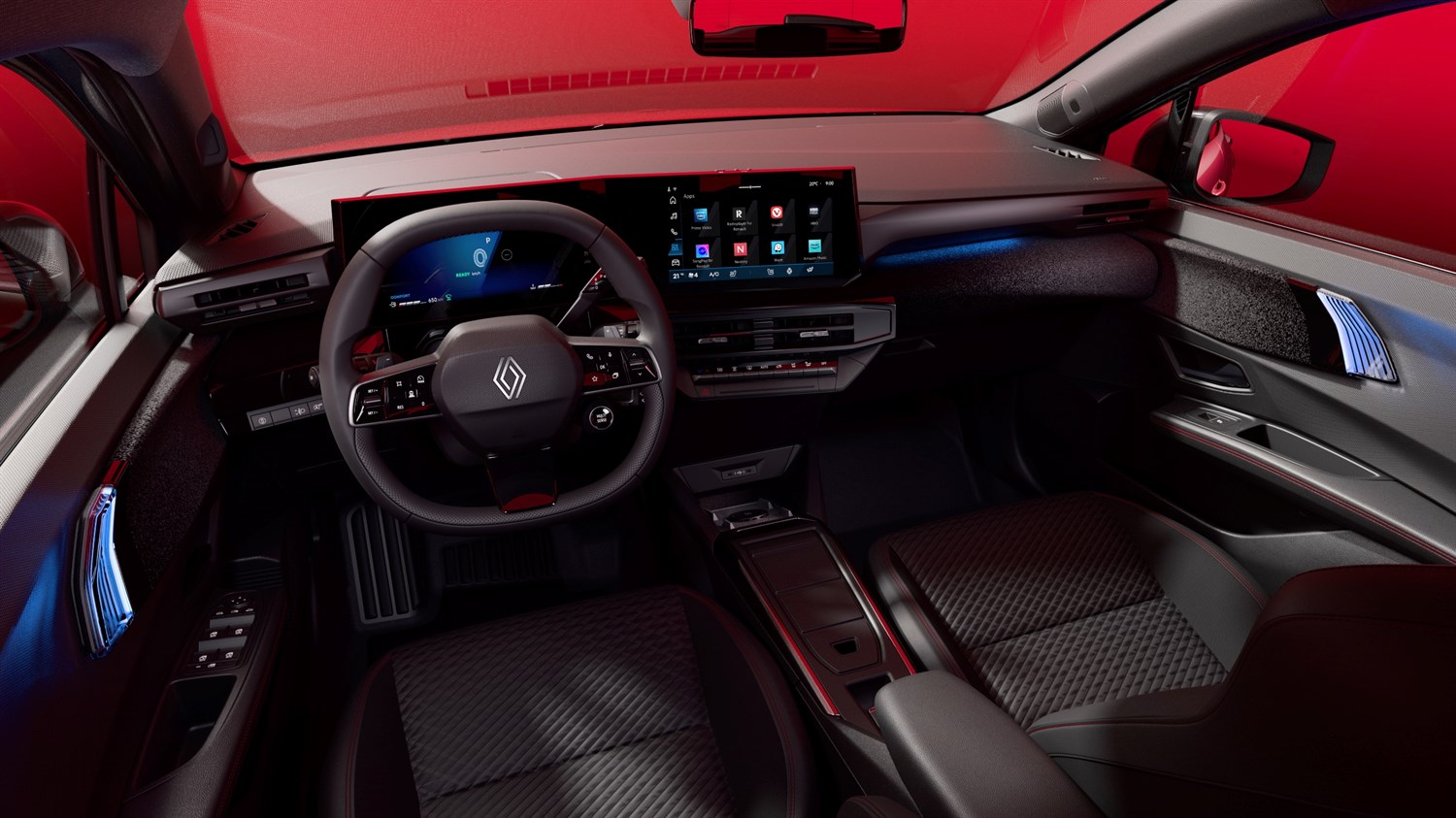Notranjost rdečega Renault Clio; volan, digitalni merilniki, sredinski zaslon in ročni menjalnik.