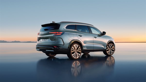 Renault Espace v svetlo modro-srebrni barvi, pogled od zadaj-desno med sončnim zahodom.