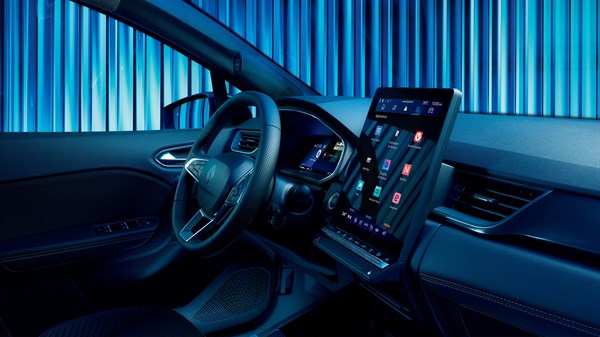 Notranjost vozila Renault, osvetljena z modro svetlobo, poudarja digitalni zaslon na sredinski konzoli in volan s sodobnim dizajnom.